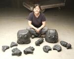 Junko Iijima sits next to her cast iron art pieces. If you look closely, you'll notice the pieces are from easily identifiable icons of pop culture like Mickey Mouse and Hello Kitty.