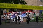 Portland police form a perimeter around the Portland State University library on Thursday, May 2, 2024, while other officers clear protesters from the building. People opposing Israel's war in Gaza took over the library Monday, leading to a standoff with police and university officials.