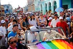 FILE - Mariela Castro, director of Cuba's National Center for Sexual Education, waves from a convertible classic car during a parade marking the International Day Against Homophobia, Transphobia and Biphobia, in Pinar Del Rio, Cuba, May 17, 2018. For years, the movement for LGBTQ+ rights has been proudly led by Cuba’s best-known advocate for gay rights: Mariela Castro, daughter of former President Raul Castro and niece of his brother Fidel.