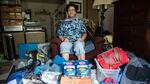 Brook Gowin poses for a photo with the supplies she has left after living off of her her emergency preparedness kit for a weekend.