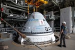 In this photo provided by NASA, the Boeing Starliner spacecraft is lifted for mounting on a United Launch Alliance Atlas V rocket at Cape Canaveral Space Force Station in Florida on Tuesday, April 16, 2024.