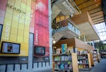 Inside of a library with shelves of books and brightly colored walls.