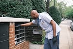 Abernathy checks a cluster mailbox in Potomac, Md., where he is assigned to what he calls a “retirement route.”