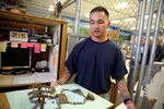 Toshio Takanobu, president of the Asian Pacific Family Club at the Oregon State Penitentiary shows off his original plan for the garden, which he put together using paper mache. 