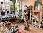 Rachael Hofmann, owner of Raylee Consignment Boutique, poses in the store with her dog Biggie Smalls on Jan. 23, 2024, in Portland.