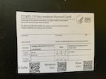 A card with proof of COVID-19 vaccination.