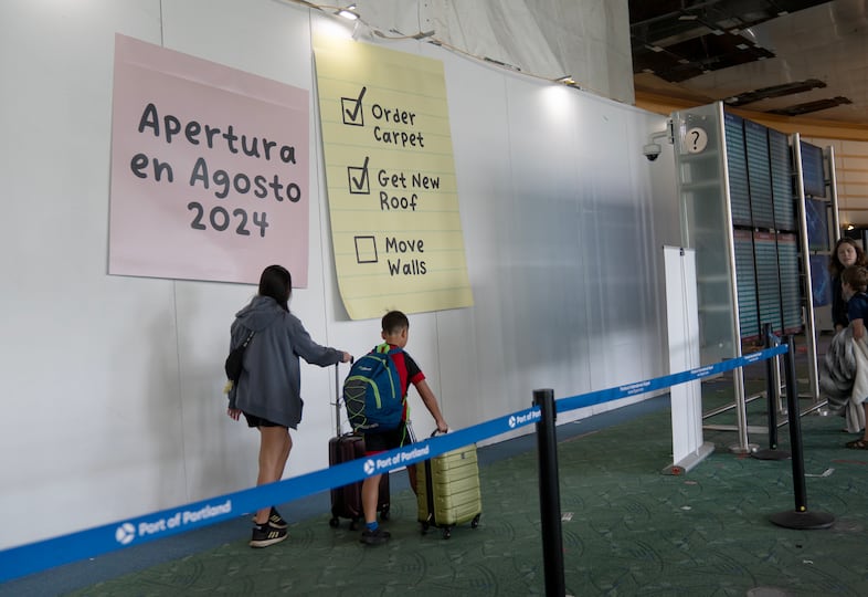 Passengers traveling through Portland International Airport, Aug. 2, 2024. Construction will continue at the airport as the project moves into the next phase, estimated to be completed in early 2026.