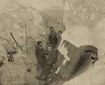 Whaling crew members trapped by Arctic ice blasting a wreck for firewood.