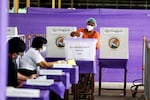 FILE - A voter casts ballot at a polling station on Nov. 8, 2020, in Yangon, Myanmar. (AP Photo/Thein Zaw, File)