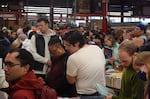Dan Kolenberg (center) looks amid shelves of surplus books at the Powell's Books Warehouse Sale. He was one of thousands to visit the warehouse for during the sale.