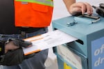 A ballot is dropped off at the Washington County Elections Office in Beaverton, Ore., on Nov. 5, 2018.