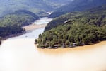 Marine One, with President Biden on board, flies over Lake Lure near Chimney Rock, N.C., southwest of the Baxter International plant closed by damage from Hurricane Helene.