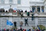 Supporters of President Donald Trump climb the west wall of the the U.S. Capitol on Wednesday, Jan. 6, 2021, in Washington.