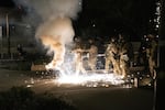 Federal law enforcement officers fire impact munitions and tear gas at protesters demonstrating against racism and police violence in front of the Mark O. Hatfield federal courthouse on July 16, 2020. 