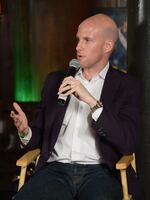 In this file photo, sportswriter Grant Wahl speaks during a panel discussion in New York in 2014. He died Friday in Qatar while covering the Argentina-Netherlands World Cup quarterfinal.