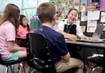 Teacher candidate April Stephens works with students on reading skills at Metzger Elementary School in Tigard on Aug. 7, 2025. The program is part of a partnership with Portland State University that helps train future educators while teaching kids math and reading skills.