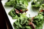 Easy-to-make Korean Lettuce Tacos With Sautéed Steak combine hot (flavors) and cold (crisp lettuce) for an Asian-inspired hors d'oeuvre. The steak can be grilled when weather permits.