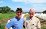 Ben Smith (left) and his father, Gary Smith at Maple View Farm in Sequim, Washington, which has been in their family for four generations.
