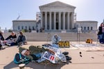 Activists demonstrate at the Supreme Court as the justices consider a challenge to rulings that found punishing people for sleeping outside when shelter space is lacking amounts to unconstitutional cruel and unusual punishment, on Capitol Hill in Washington, Monday, April 22, 2024.