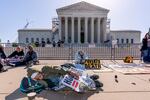 Activists demonstrate at the Supreme Court as the justices consider a challenge to rulings that found punishing people for sleeping outside when shelter space is lacking amounts to unconstitutional cruel and unusual punishment, on Capitol Hill in Washington, Monday, April 22, 2024.