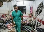 A man inspects the damage in a room following Israeli bombardment at Nasser Hospital in Khan Younis, southern Gaza Strip, on Dec. 17.