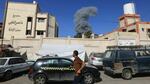 People watch as smoke and dust ascend following Israeli bombardment, in Khan Yunis in the southern Gaza Strip, on Thursday.