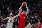 Portland Trail Blazers center Donovan Clingan (23) grabs a rebound between Indiana Pacers center Jay Huff (32) and guard Quenton Jackson (29) during the first half of an NBA basketball game in Indianapolis, Wednesday, March 18, 2026.