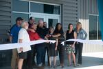 Portland Community College leaders, faculty and others come together to cut the ribbon for the grand opening of the college's Dealer Service Technology Building on July 26, 2022.