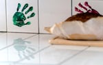 Reminders of Sarah Zuber are throughout the Zuber home, including her green handprint on the counter backsplash, near a freshly baked loaf of bread.