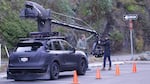 A film crew shoots a car commercial.