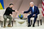 President Joe Biden, right, reaches to shake the hand of Ukraine's President Volodymyr Zelenskyy during a meeting on the sidelines of the NATO Summit in Washington, Thursday, July 11, 2024.