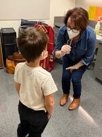 Tigard-Tualatin School District Superintendent Sue Rieke-Smith preparing to administer a rapid COVID-19 test to a student at Durham Elementary School which shifted to online instruction this week amid the omicron surge.