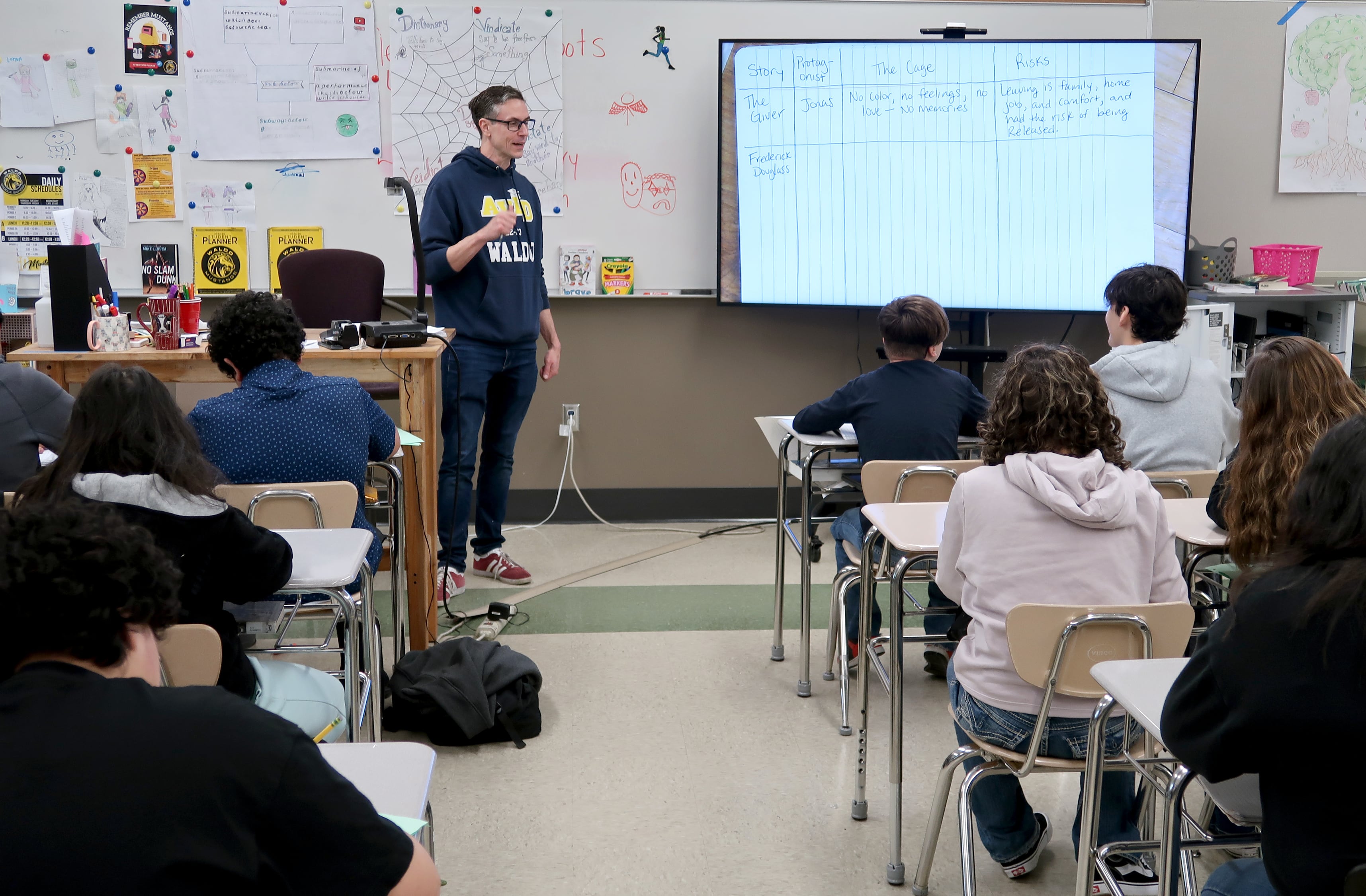 David Mann, center, an English teacher at Waldo Middle School in Salem, Ore., responds to student David