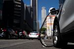 An electric vehicle is plugged into a charger in Los Angeles, Thursday, Aug. 25, 2022. California plans to require all new cars, trucks and SUVs to run on electricity or hydrogen by 2035 under a policy approved Thursday by regulators that seeks a dramatic cut in carbon emissions and an eventual end to gasoline-powered vehicles.