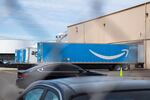 Trucks sit at the loading docks of the Amazon delivery station in northwest Portland, Ore., Friday, July 12, 2019.
