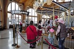 People line up Saturday, March 29, 2023, to ride the carousel in downtown Albany, where about 160,000 people ride every year, spending an average $6 on rides, food and gifts.