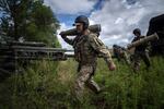 A Ukrainian serviceman carries a 155 mm artillery shell before firing at Russian positions from a U.S.-supplied M777 howitzer in the Kharkiv region, on July 14.