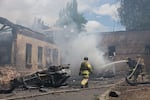 Rescue workers put out a fire at a building destroyed after a Russian strike on Zaporizhzhia, Ukraine, on Friday.