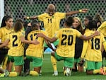Jamaica celebrates qualifying for the round of 16 after tying Brazil in Melbourne on Wednesday.