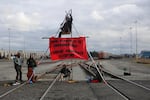 Environmental activists from Portland Rising Tide built a tripod in the middle of a rail line to block access to Terminal 5 at the Port of Vancouver on Thursday, Oct. 17, 2019. Activists attempted to block trains carrying materials for the Trans Mountain Pipeline Expansion Project in Canada.