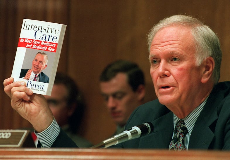 Senate Finance Committee Chairman Bob Packwood, Oregon, holds a book entitled "Intensive Care" by Ross Perot during hearings dealing with the future of Medicare on Capitol Hill Wednesday, Aug. 30, 1995.