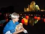 Dr. Hideko Tamura Snider lights a peace lantern in Hiroshima on the 70th anniversary of the Hiroshima bombing.