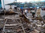 Palestinians look at the aftermath of the Israeli airstrike on a U.N.-run school in the Nuseirat refugee camp in the Gaza Strip on July 6.