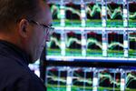 A trader works on the floor of the New York Stock Exchange (NYSE) at the opening bell in New York City on March 10, 2025.