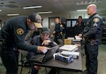 Bike squad officers David Baer, left, and Donny Mathew, center, confer before heading out on patrol in downtown Portland with Sgt. Jerry Cioeta, right.