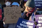 FILE - Demonstrators rally in support of federal workers outside of the Department of Health and Human Services, Feb. 14, 2025, in Washington.