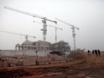 Building cranes tower over a new Hindu temple that will be consecrated with Indian Prime Minister Narendra Modi in attendance on Monday.