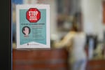 FILE - A sign warning of measles is posted on a glass door in the family medicine wing of at the Texas Tech Physicians of the Permian Basin Monday, Feb. 24, 2025, in Odessa, Texas.