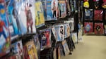 Children's Halloween costumes hang on a wall at a Spirit Halloween store. Like pumpkin patches, the seasonal pop-up shops are a signal that fall is upon us.