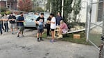 People wait to gather water at Mountain Valley Water in the aftermath of Hurricane Helene in West Asheville, N.C., Monday, Sept. 30, 2024.